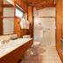 Rendezvous Mendocino bathroom in Gualala with wood-paneled walls, walk-in shower, and vanity
