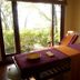 Ananda in the Himalayas in Rishikesh spa treatment room with massage table by garden-view windows
