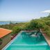 Ossanzaia Bilene Lodge in Bilene with infinity pool, lake view, and shaded lounge chairs