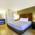 Copley Inn & Suites By OYO Akron Oh guest room with king bed and wood floor in Copley