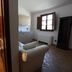 Agriturismo Lapone in Orvieto: bathroom with tub, bidet, and adjacent living area with sofa and window
