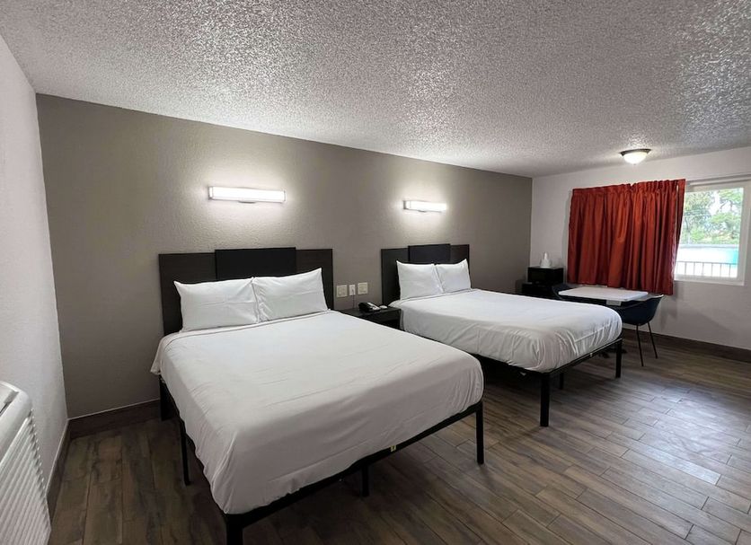 Motel 6-Orange, CA - Anaheim room with two beds, wood-look floors, and a window in Orange