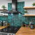 Candlewick Inn in Eureka Springs kitchen with teal tile backsplash, wood shelves, and countertop appliances
