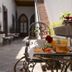 Breakfast tray on a wrought-iron table at El Serafin Hotel Boutique in Santiago de Querétaro courtyard