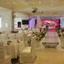 Century Palace Hotel Huiyang in Huizhou banquet hall with decorated aisle, round tables, and stage