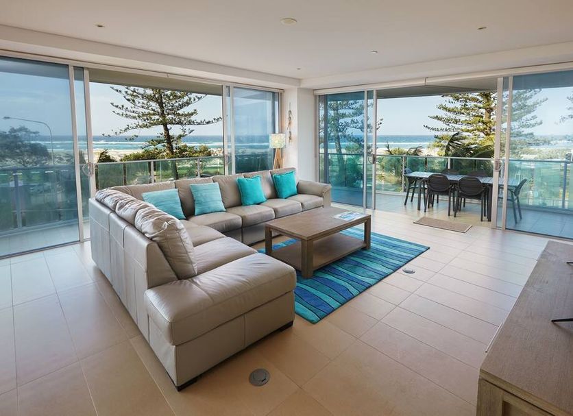 Nirvana By The Sea in Coolangatta, living room with balcony and ocean view through glass doors
