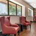 Red Roof Inn Detroit-Rochester Hills/Auburn Hills lobby seating area with red chairs and wood floors