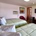 Best Motel Bowling Green room with two beds, TV, dresser, chair and wall mirror