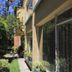 Hostal Bogotá Real in Bogotá with garden walkway beside the building and large windows