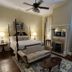 1842 Inn in Macon: elegant four-poster bedroom with fireplace, sitting area, and patterned rug