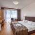 Hotel Barátság, Hajdúszoboszló guest room with double bed, desk, seating area and balcony doors