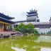 Hanting Hotel Guangzhou Zhongshanba Metro Station in Guangzhou with Chinese-style buildings and a pond