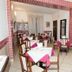 Hotel Chopin Genoa dining room with set tables and red-tiled archway