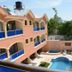 Tabarre's Palace, Port Au Prince: peach hotel with blue balconies and a courtyard pool