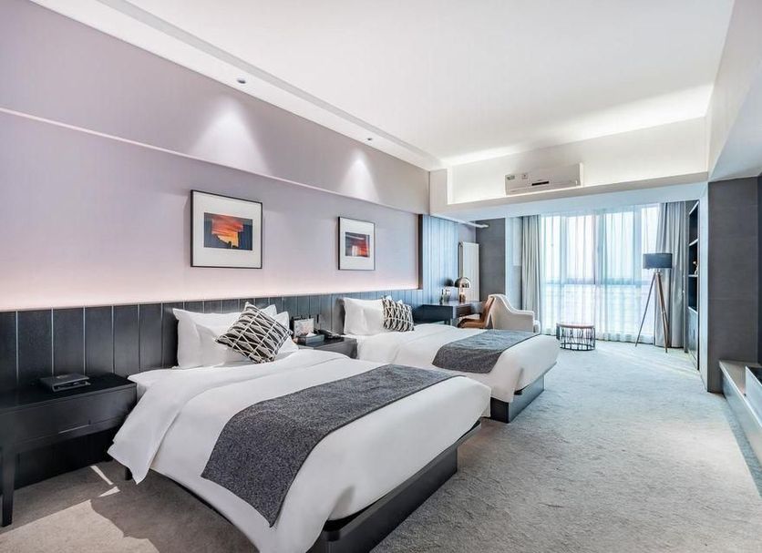Beijing Lian Jie Hotel in Beijing guest room with two twin beds and large window view
