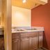 Industry Inn & Suites in La Puente: bathroom vanity with sink, mirror, and wood cabinets
