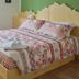 Al Riparo Affittacamere in Finale Ligure: bedroom with double bed, heart-pattern bedding, and towels