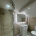 Tumbleweed Cottage in Newark-on-Trent bathroom with glass shower, vanity sink, mirror and toilet