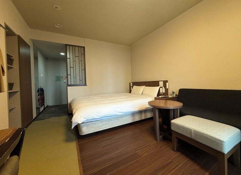 Dormy Inn Express Asakusa Tokyo guest room with bed, sofa, and side table