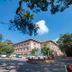 Evershine Resort & Spa in Mahabaleshwar exterior with circular driveway, cars, and tree-lined grounds