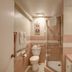 The Tides Laguna Beach bathroom with walk-in shower, toilet, and pink tile accents