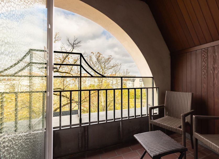 Garner Hotel Berlin - Messe by IHG balcony with chairs and arched city view in Berlin
