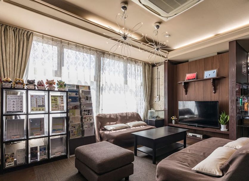 Wing Izumi guest lounge in Izumi with sofa, ottoman, coffee table and TV