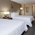 Hilton Garden Inn Roseville guest room with two double beds, desk, and striped carpet