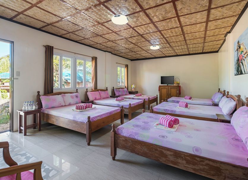 Punta Riviera Resort Bolinao room with multiple twin beds and windows in Bolinao