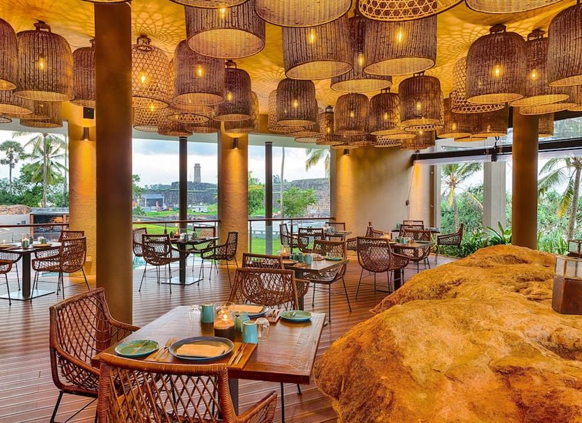 Le Grand Galle in Galle, open-air restaurant with woven pendant lights and sea views