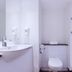 Travelodge London Twickenham bathroom with sink, toilet, and walk-in shower