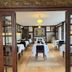Hotel Strandly Skagen dining room with set tables, wooden floors and tall windows in Skagen