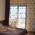 Magic Club Bușteni hotel room with bed, sheer curtains, and balcony door