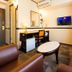 Toyoko Inn Keio sen Hashimoto eki Kita guchi room with desk, TV, sofa seating and oval table in Sagamihara