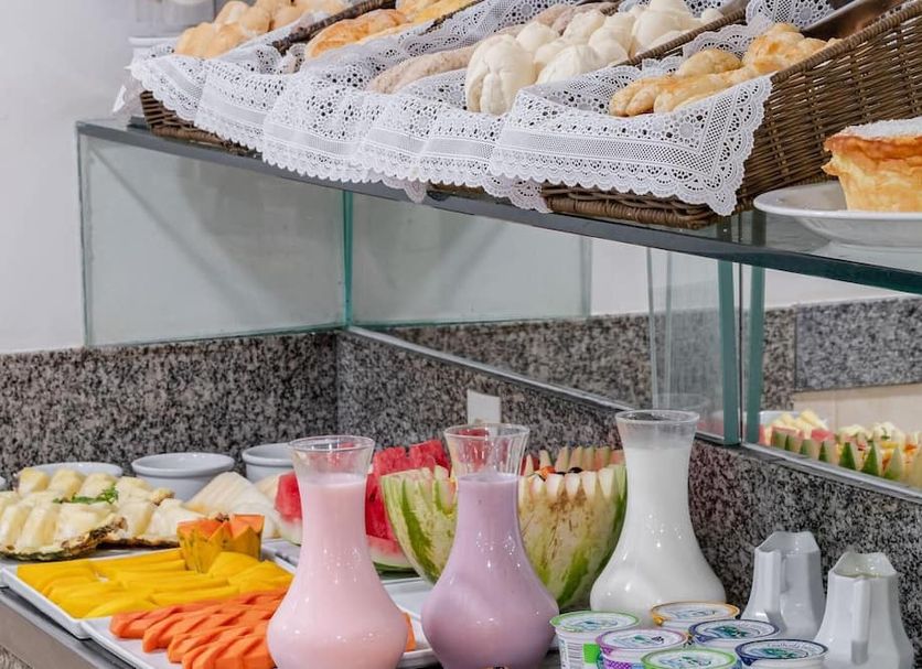 Citi Hotel Residence Caruaru breakfast buffet with assorted breads, fruit, cold cuts and juices in Caruaru