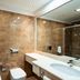 Delta Hotels by Marriott Olbia Sardinia bathroom with marble tile, vanity sink and glass shower in Olbia