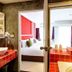 Raha Grand Hotel Patong bathroom with sink, looking into a bright bedroom in Patong