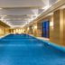 Somerset Xindicheng Xi'an indoor lap pool in Xi'an with blue-lit water and lounge seating