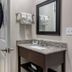 Spark By Hilton Evansville Downtown bathroom with vanity, mirror, toilet, and towel rack in Evansville