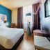 NYX Hotel Mannheim by Leonardo Hotels guest room with king bed, desk by window, and modern seating