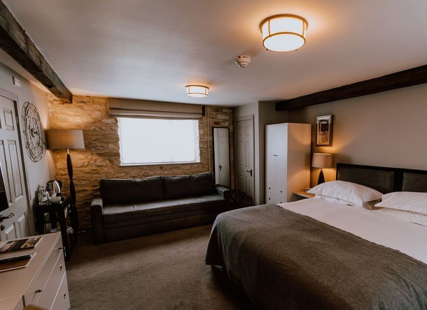 Widbrook Grange Bradford-on-Avon guest room with double bed, sofa, and window seat