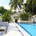 Winslow's Bungalows - Key West Historic Inns poolside loungers beside a tropical outdoor pool in Key West