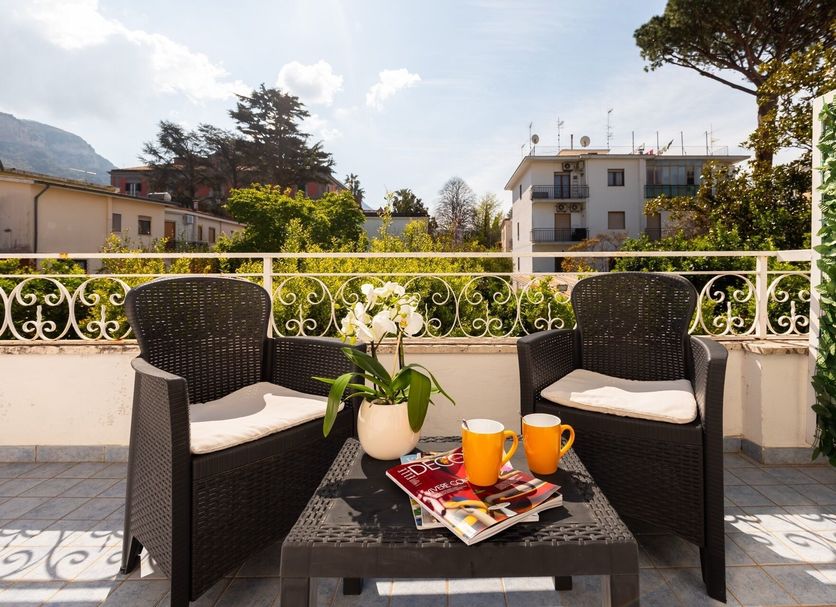 Terrace seating at Yourhome - Villa Sorrento in Meta with two chairs, table, flowers, and mountain views