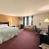 Knights Inn Kirksville guest room with king bed, sofa, desk and TV in Kirksville
