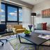 Fraser Place Antasya Istanbul living room with city view, sofa, armchair and coffee table
