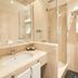Hotel de la Ville Monza bathroom with marble sink, glass shower and towel warmer