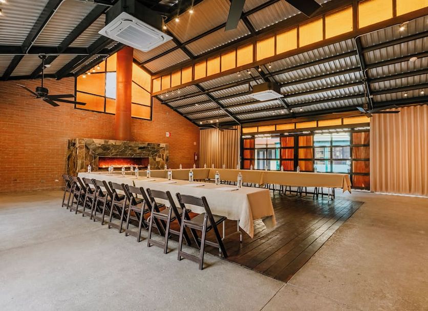 Hotel La Pinta, Ensenada: rustic event hall with long banquet tables and folding chairs