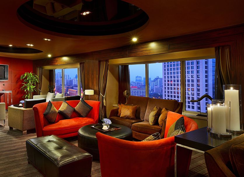 Sofitel Xian On Renmin Square lounge with red seating and large city-view windows in Xi'an