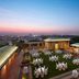 Rooftop event lawn at ITC Gardenia, a Luxury Collection Hotel, Bengaluru with cocktail tables at dusk