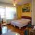 Pension Mari Asun room in Pamplona with double bed, balcony door and colorful armchair